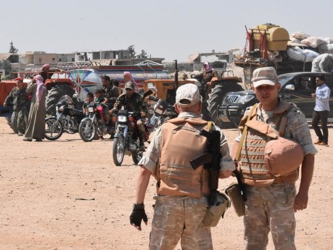 Russian and Syrian forces stand guard at the eastern edge of the last rebel-held province, Idlib. Picture: AFP